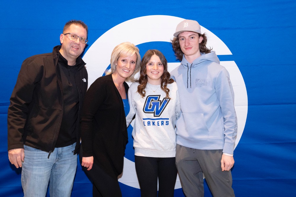 Girl with her family in front of GV backdrop